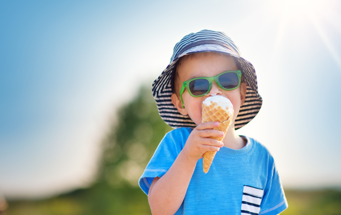 Child eating ice cream in the sun