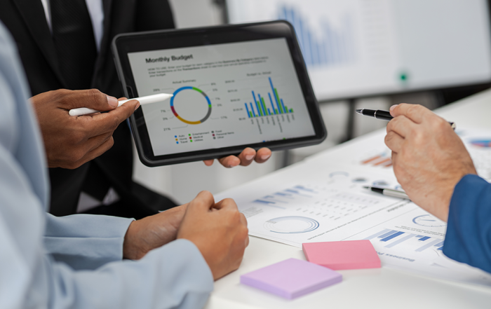 Hands showing screen with financial data